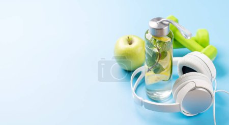 Photo for Healthy lifestyle, sport and diet concept. Dumbbells, headphones and healthy food. With space for your text - Royalty Free Image