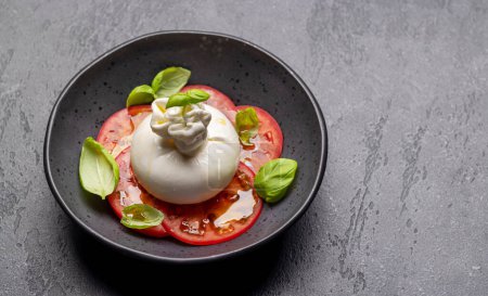 Photo for Antipasto with burrata cheese, tomatoes and basil. Italian cuisine. With copy space - Royalty Free Image