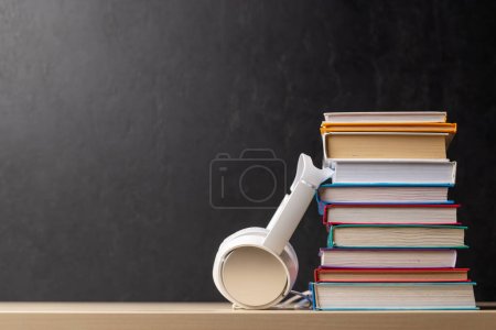 Photo for Stack of books and headphones on a table with copy space - Royalty Free Image