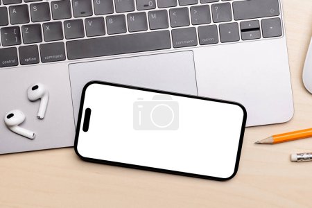 Photo for Blank white screen smartphone on a desk, perfect for your design mockup - Royalty Free Image