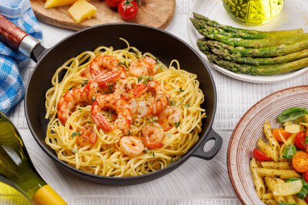 Photo for A delightful Italian pasta adorned with shrimps with thyme, creating a perfect seafood indulgence - Royalty Free Image