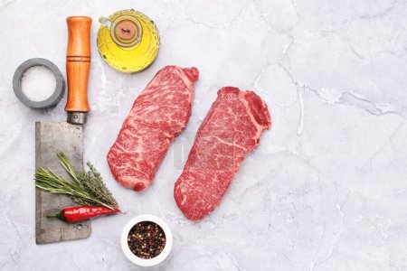 Photo for Prime marbled beef steaks. Raw striploin steak. Flat lay with copy space - Royalty Free Image