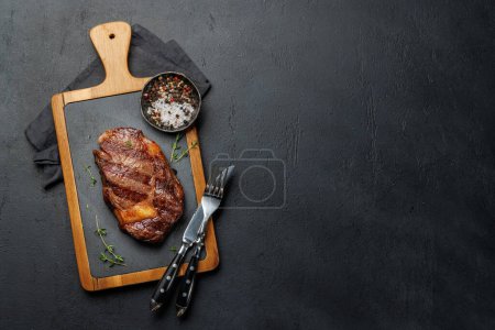 Photo for Deliciously juicy beef ribeye steak, perfectly cooked and ready to be savored. Flat lay with copy space - Royalty Free Image