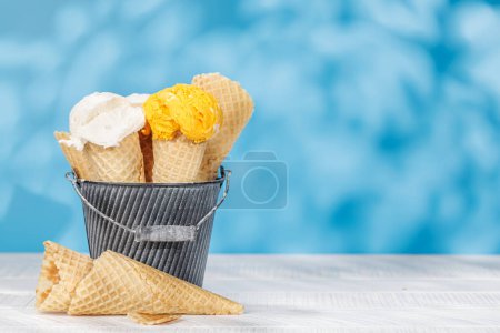 Photo for Refreshing ice cream in waffle cones treats with a hint of zesty lemon flavour - Royalty Free Image
