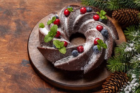 Foto de Pastel de Navidad decorado con arándanos, arándanos y menta. Con espacio de copia - Imagen libre de derechos