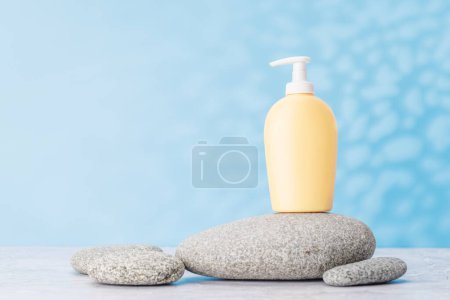 Photo for A visually appealing backdrop with smooth sea pebbles and toiletry tube, perfect podium for showcasing your product - Royalty Free Image