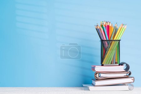 Photo for An organized arrangement of colorful pencils and notepads on an office desk, offering ample copy space for your creative ideas or text - Royalty Free Image