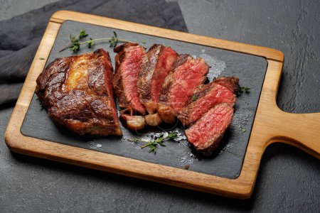 Photo for Deliciously juicy sliced beef ribeye steak, perfectly cooked and ready to be savored - Royalty Free Image
