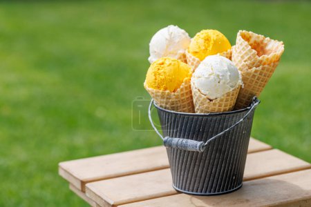 Photo for Assorted ice cream flavours in delightful waffle cones, a treat for every taste bud. Outdoor with copy space - Royalty Free Image