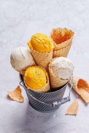 Photo for Lemon ice cream in delightful waffle cones, a treat for every taste bud. Over stone background - Royalty Free Image