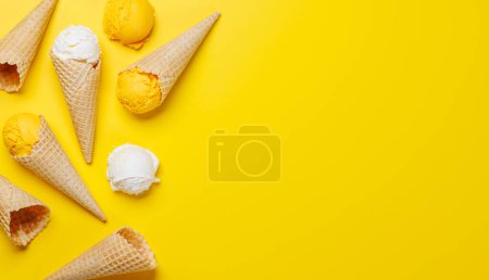 Photo for Assorted ice cream flavours in delightful waffle cones, a treat for every taste bud. Over yellow background with copy space, flat lay - Royalty Free Image