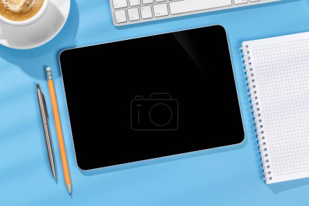 Photo for Tablet with blank screen on business office desk. Flat lay workspace with sunny light and copy space - Royalty Free Image