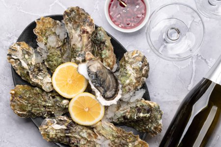 Téléchargez les photos : Huîtres fraîches avec verres de vin mousseux. Pose plate - en image libre de droit