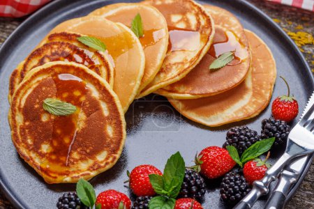 Photo for Tasty homemade pancakes with berries and tea - Royalty Free Image
