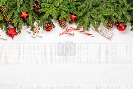 Photo for Christmas fir tree branch with decor and space for greetings text. Flat lay - Royalty Free Image