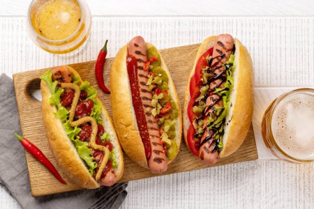 Foto de Various hot dog and beer. Homemade hotdogs on cutting board. Flat lay - Imagen libre de derechos
