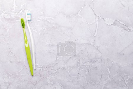 Photo for A clean and refreshing image featuring toothbrushes, promoting oral hygiene and a bright smile. Flat lay with copy space - Royalty Free Image