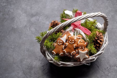 Photo for Basket with Christmas gingerbread cookies fir tree branches. Flat lay with space for your Xmas greetings - Royalty Free Image