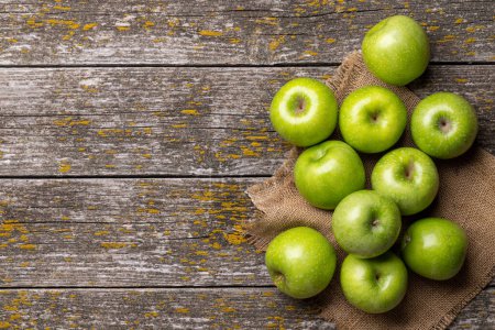 Photo for Fresh green apples on wood table. Flat lay with copy space - Royalty Free Image