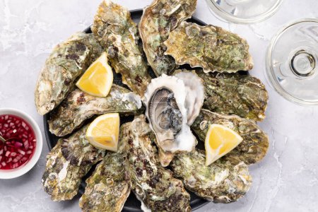 Photo for Fresh oysters with glasses of sparkling wine. Flat lay - Royalty Free Image