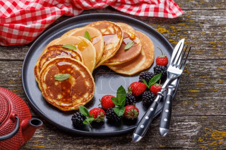 Photo for Tasty homemade pancakes with berries and tea - Royalty Free Image