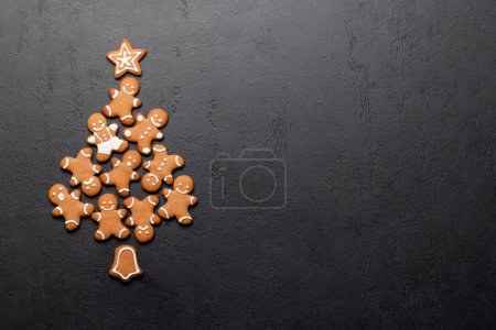 Photo for Christmas gingerbread cookies in fir tree shape and space for greetings text. Flat lay - Royalty Free Image