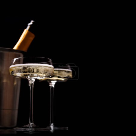 Photo for Two champagne glasses on a black background with copy space - Royalty Free Image