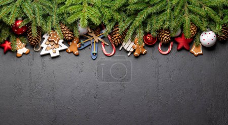 Photo for Christmas fir tree branch with decor, cookies and space for greetings text. Flat lay - Royalty Free Image