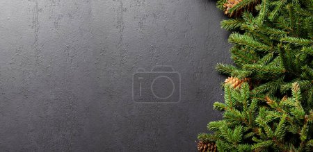 Photo for Christmas fir tree branch frame over stone with space for greetings text. Flat lay - Royalty Free Image