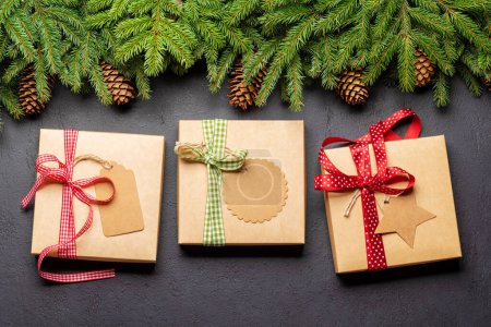 Photo for Christmas fir tree branch and gift boxes. Flat lay - Royalty Free Image