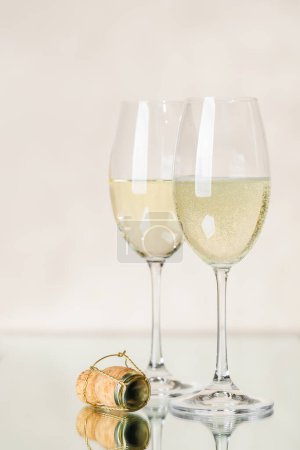 Photo for Two champagne glasses on a beige background - Royalty Free Image