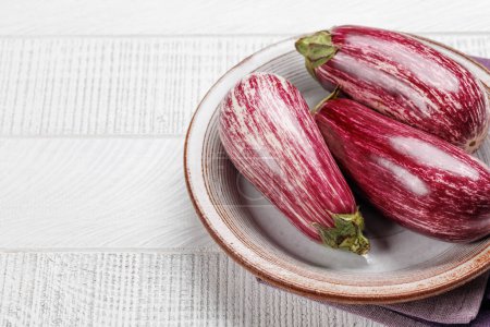 Photo for Eggplant, a glossy and fresh vegetable on wooden table. With copy space - Royalty Free Image