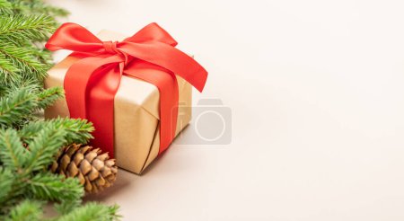 Photo for Xmas fir tree branch, Christmas gift box and space for greetings text - Royalty Free Image