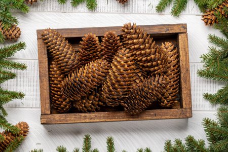 Photo for Box with Christmas fir tree cones. Flat lay - Royalty Free Image
