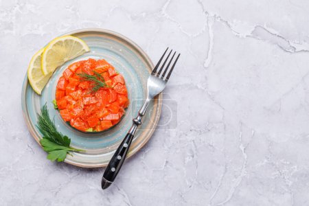 Photo for Delicious salmon and avocado tartare. Flat lay with copy space - Royalty Free Image