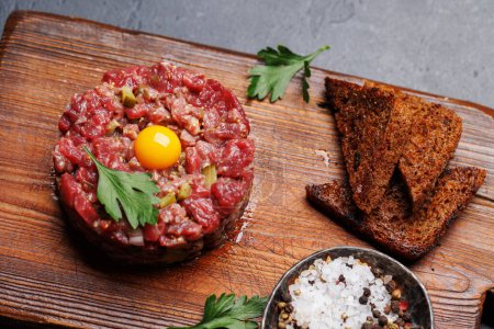 Savory beef tartare with pickled gherkins and brown bread toasts