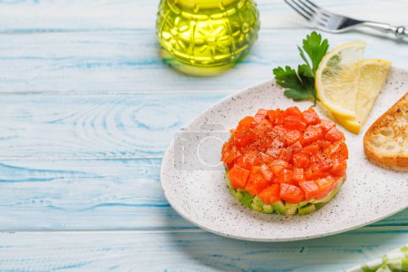 Photo for Delicious salmon and avocado tartare with crispy toasts. With copy space - Royalty Free Image