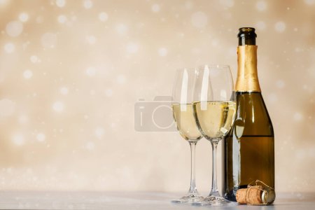 Photo for Two champagne glasses and bottle. Christmas greeting card template with copy space - Royalty Free Image