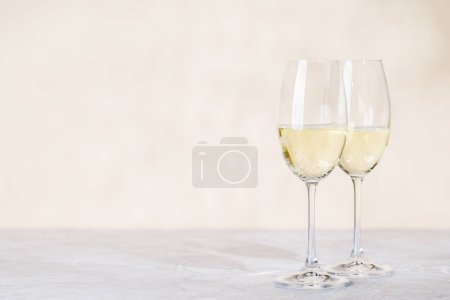 Photo for Two champagne glasses on a beige background with copy space - Royalty Free Image