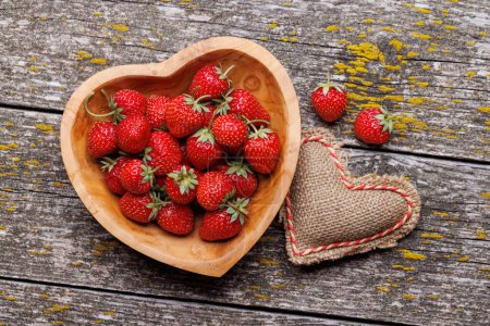 Photo for Strawberries in heart bowl - Valentine's Day. Flat lay - Royalty Free Image