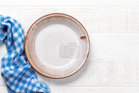 Photo for Mockup for a delicious meal. Empty plate on a table. Flat lay with copy space - Royalty Free Image