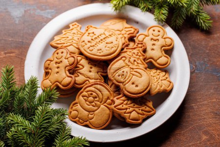 Photo for Diverse Christmas gingerbread cookies, festive sweetness on a plate - Royalty Free Image