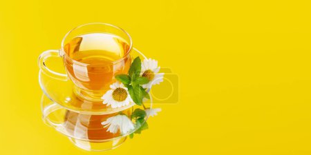 Photo for Soothing herbal tea blend with mint and chamomile. On yellow background with copy space - Royalty Free Image