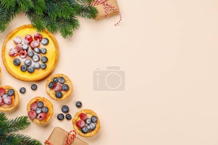 Photo for Festive delight: Christmas cupcakes adorned with berries. Flat lay with copy space - Royalty Free Image