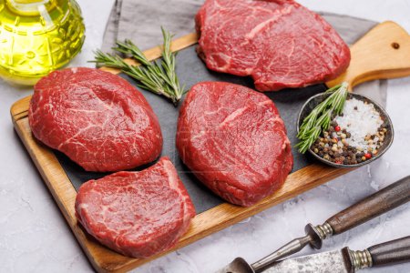 Photo for Raw beef fillet steaks on a cutting board, fresh and uncooked - Royalty Free Image
