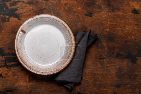 Photo for Mockup for a delicious meal. Empty plate on a table. Flat lay with copy space - Royalty Free Image