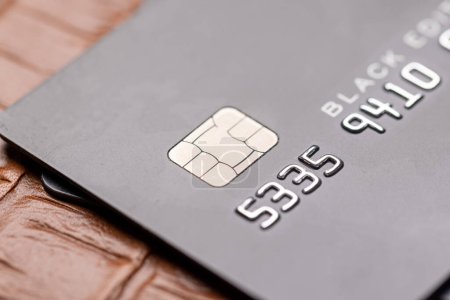 Photo for Closeup of black credit card on leather notepad. Premium banking concept - Royalty Free Image