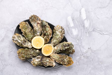 Photo for Fresh oysters and sparkling wine glasses. Flat lay - Royalty Free Image