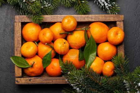Foto de Alegría festiva de los cítricos: mandarinas en una caja con temática navideña, puesta plana - Imagen libre de derechos
