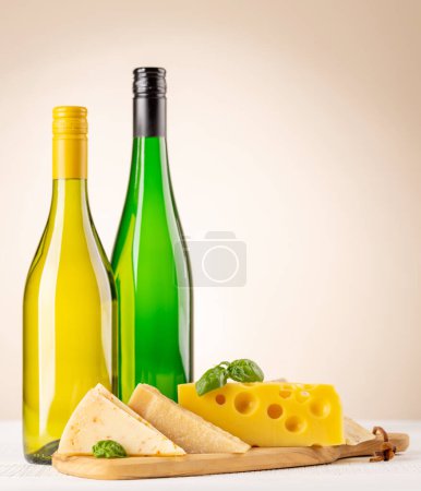 Photo for Various cheese on board and white wine. Over beige background with copy space - Royalty Free Image